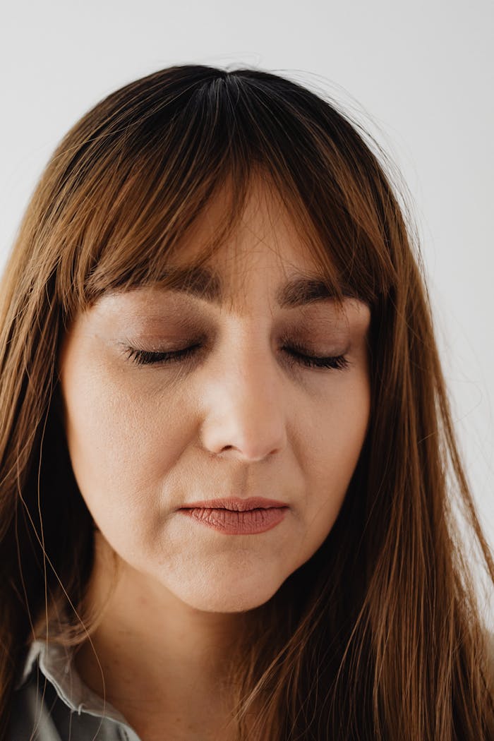 gallery-2 Close-up portrait of a serene woman with closed eyes, conveying calmness and introspection.